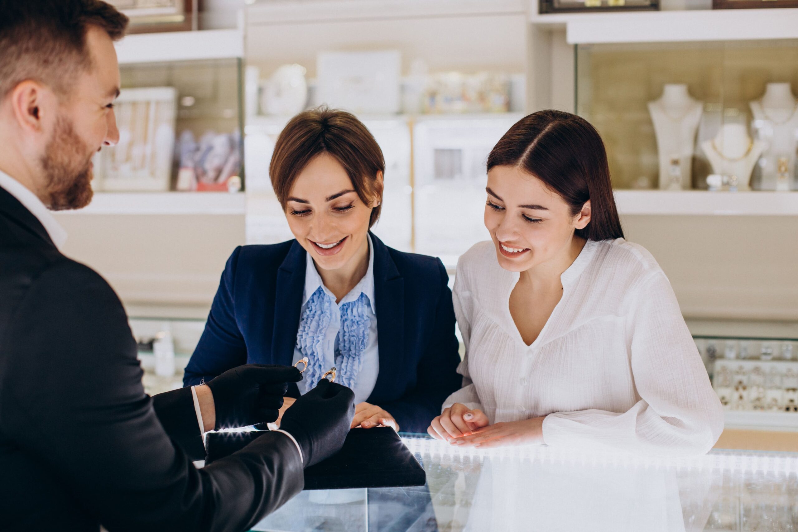 Two women sitting at a table looking at something.